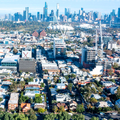 An aerial photo of Yarra with buildings, parks and infrastructure and the CBD in the background