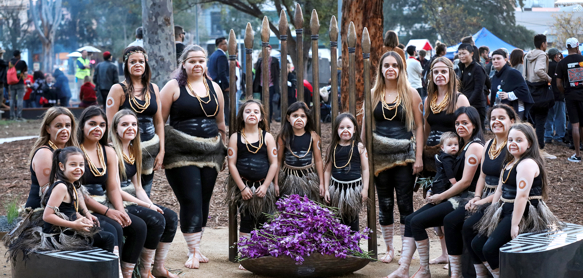 A group of women and girls in traditional Aboriginal dress and body paint